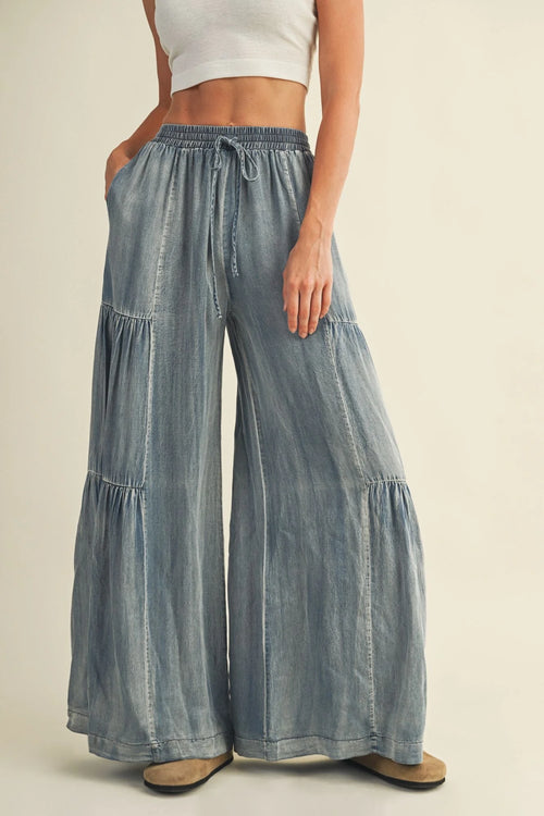 Light blue washed denim wide pants with tiered design and drawstring waist
