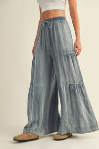 Light blue washed denim wide pants with tiered design and drawstring waistband