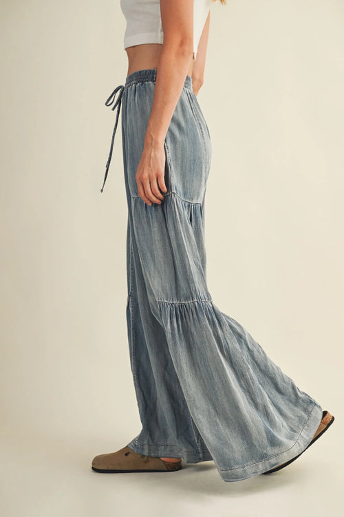 Light blue washed denim wide pants with tiered design and drawstring waist