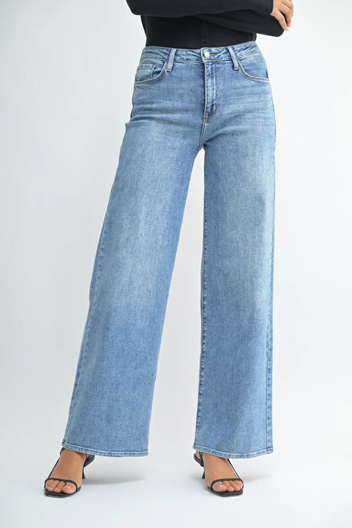 Light blue wide leg denim jeans with a raw hem from Shop Daisy for women’s boho chic clothing