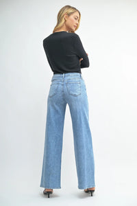 Light blue wide leg denim jeans with a straight cut in women’s boho chic clothing at Shop Daisy