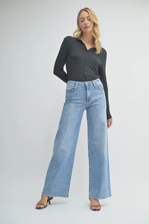 Light blue wide leg denim jeans with raw hem from Shop Daisy’s women’s boho chic collection