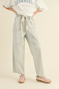 Light-colored stripe washed barrel shaped pants with pockets featuring a wide-leg design
