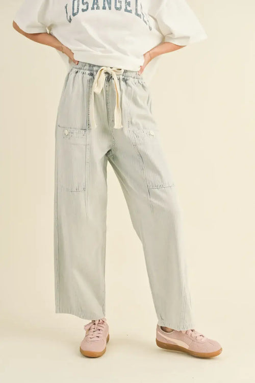 Light-colored stripe washed barrel shaped pants with pockets featuring a wide-leg design