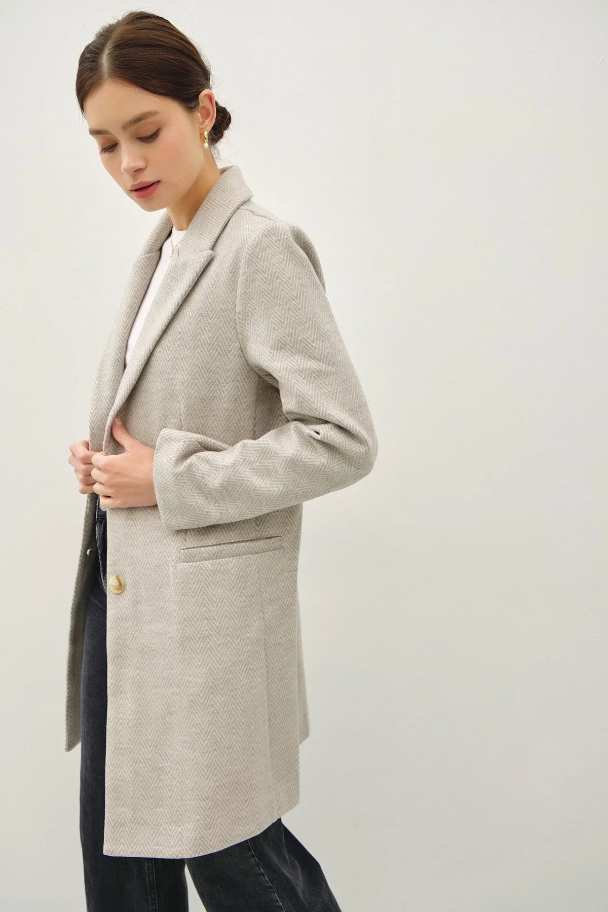 Light gray tailored double button coat with notched lapel and light chevron pattern