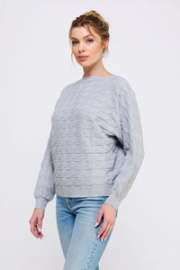 Light gray long sleeve cable knit sweater with oversized fit and balloon sleeves