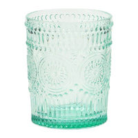Light green embossed drinking glass with intricate vertical ridges and floral motifs