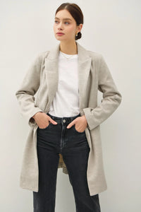 Long beige Light Chevron Pattern Double Button Coat over white top and dark jeans