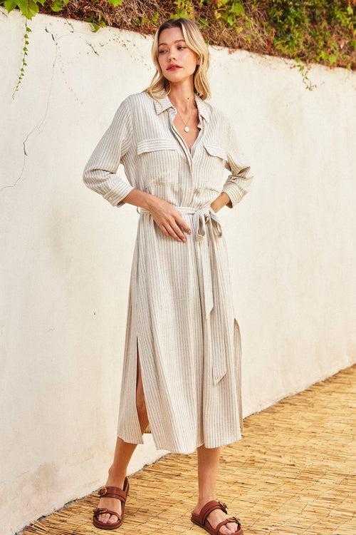 Long beige maxi shirt dress with vertical stripes, collar, and belted waist