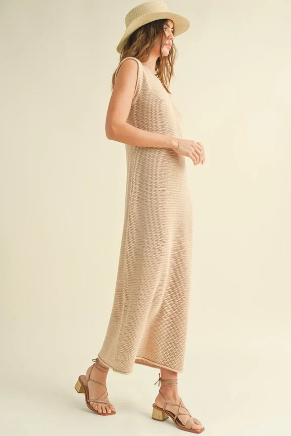 Long beige sleeveless crochet knitted dress with a wide-brimmed sun hat for summer style