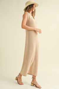 Long beige sleeveless crochet knitted dress with a wide-brimmed sun hat for summer style