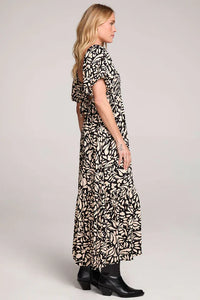 Evra Maxi Rayon Ruffle Dress with black and white pattern, short sleeves, and black boots