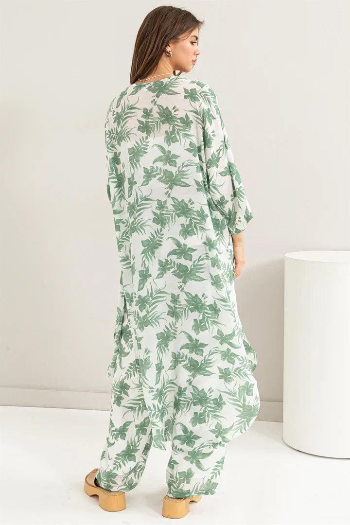 Woman wearing a flowy Floral Duster Kimono with a green leaf pattern, embodying boho style