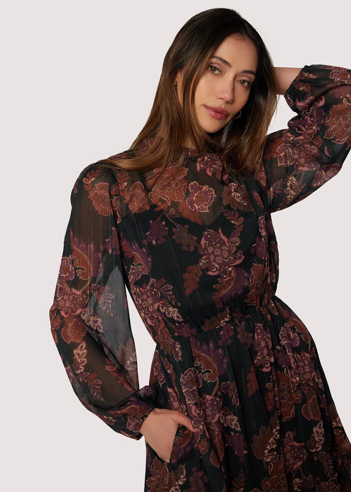 Bohemia maxi dress with floral print, long sleeves, cinched waist, dark background