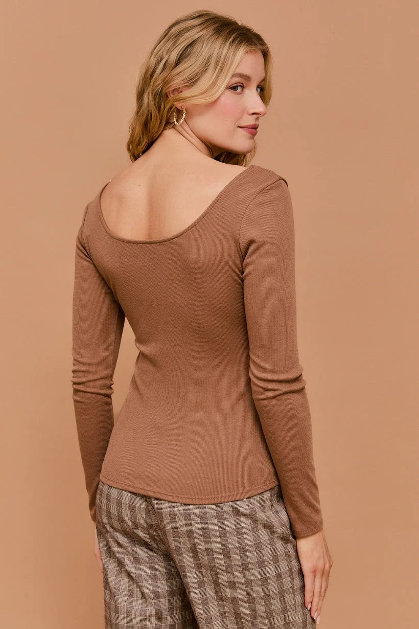 Long sleeve sweetheart rib top worn by a woman with blonde hair showcasing a low back