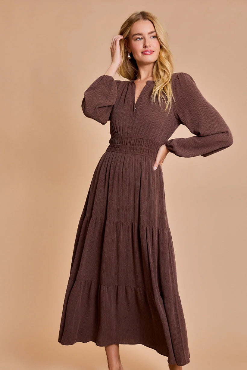 Long-sleeved brown maxi dress with tiered skirt and gathered waist in women’s boho chic clothing