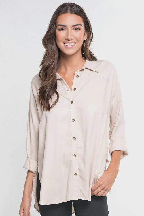 Bohemian long sleeve button down shirt with rolled cuffs and side slits in light beige