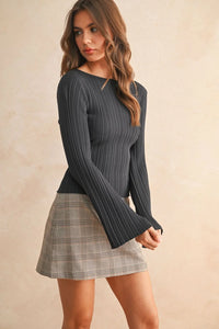 Ribbed long sleeve knitted top with boat neck and flared cuffs paired with plaid mini skirt