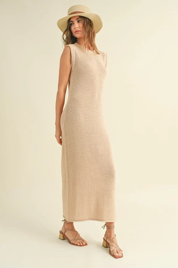 Sleeveless crochet knitted dress styled with a straw sun hat and sandals