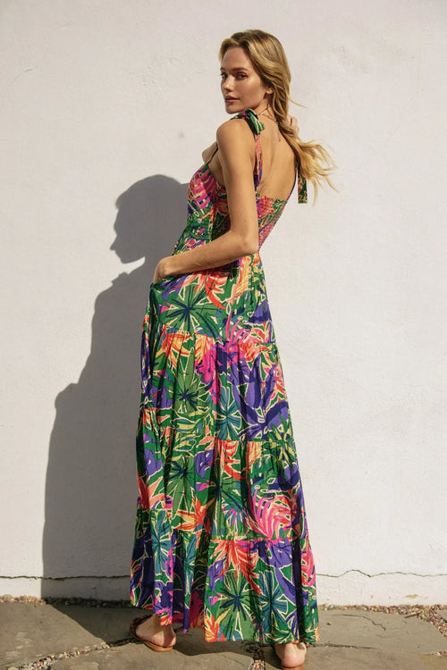 Tropical smocked tie shoulder maxi dress with vibrant leaf print and tiered design