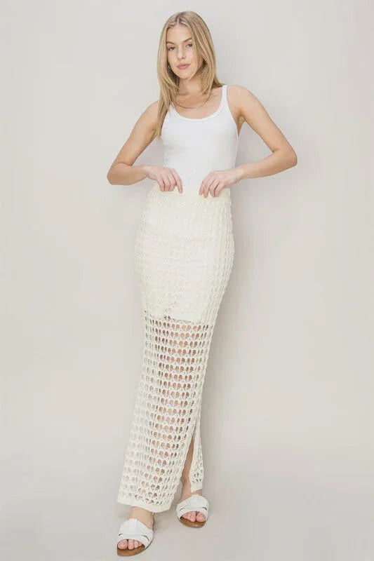 Long white sleeveless dress with crochet-style maxi skirt for a boho free spirit style