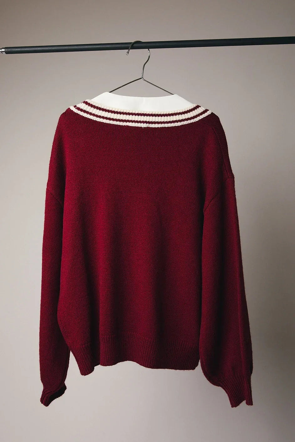 Maroon Candy Cane Graphic Cardigan with striped collar on hanger