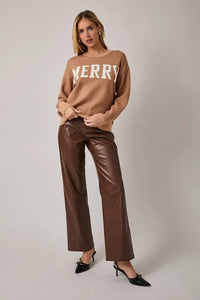 Camel merry sweater with crew neck long sleeves, brown leather pants, black heels
