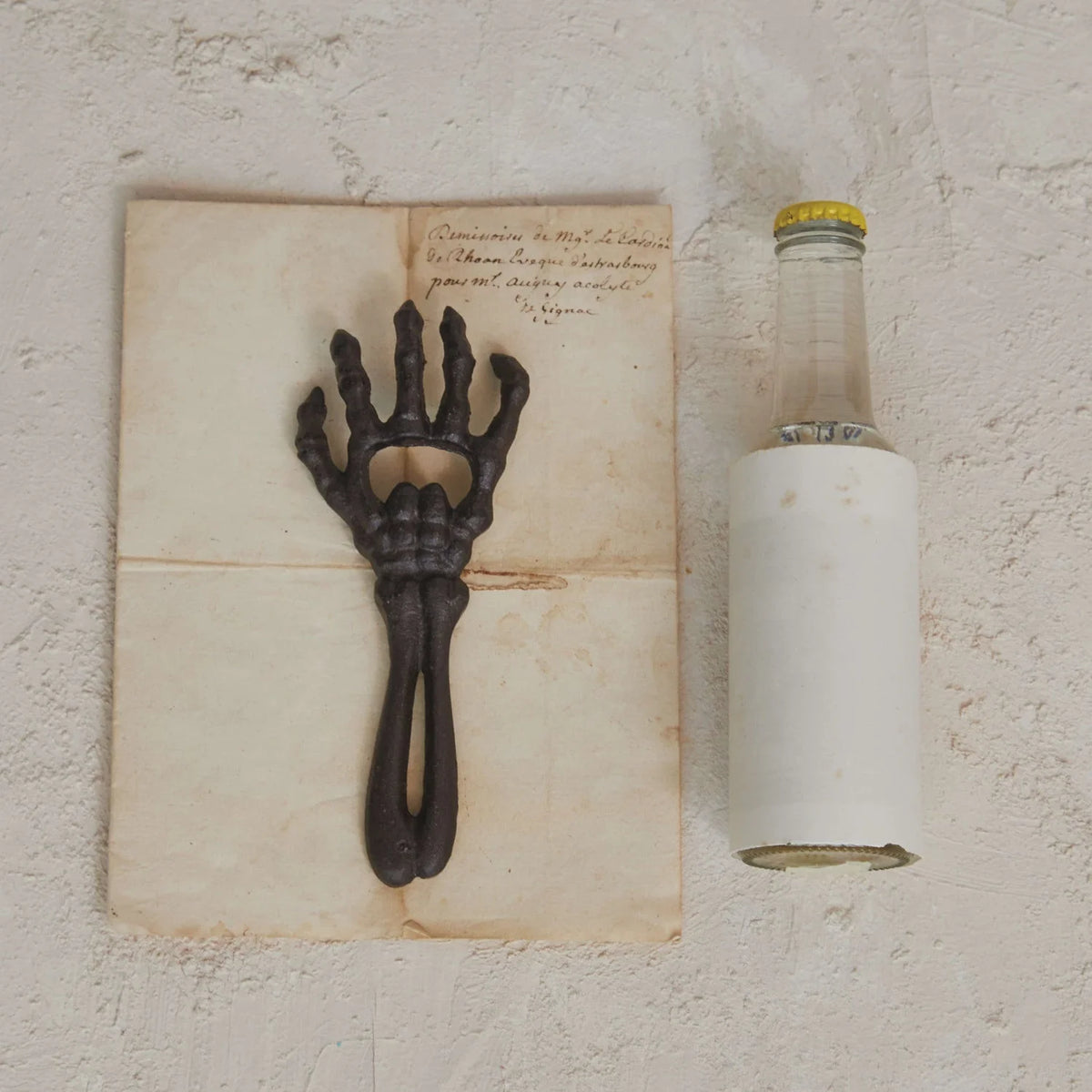 Metal hand sculpture of cast iron skeleton arm with open palm for bottle opening