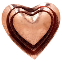 Metallic copper embossed heart dish showcasing decorative patterns for elegant trays