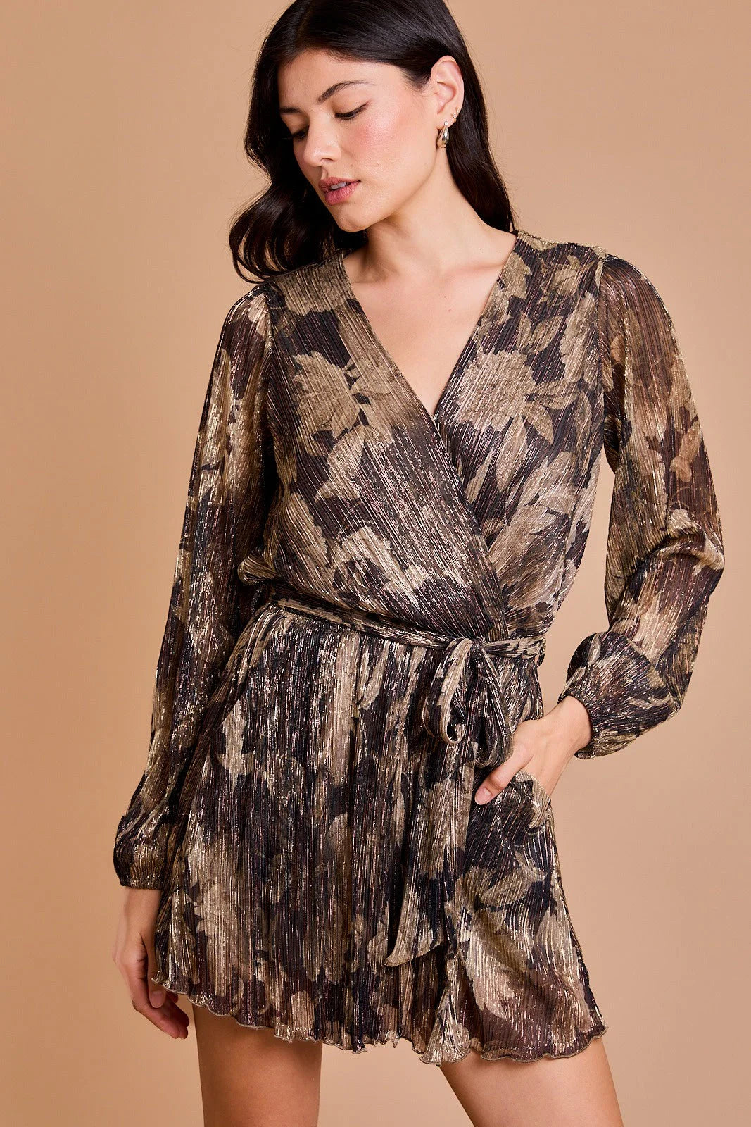 Metallic floral surplice long sleeve waist tie romper with pleated bottom showcased