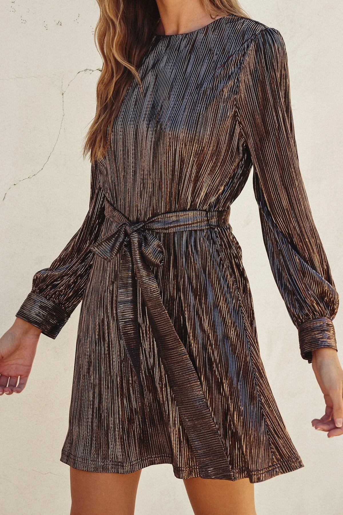 Metallic pleated mini dress with long sleeves and tie waist belt from Shop Daisy