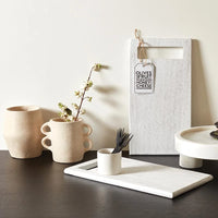 Minimalist kitchen setup featuring a Paper Mache Vase with Handles and neutral ceramic pieces