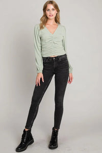 Mint green Center Ruched Micro-Rib Knit Top with long sleeves, styled with dark jeans and combat boots