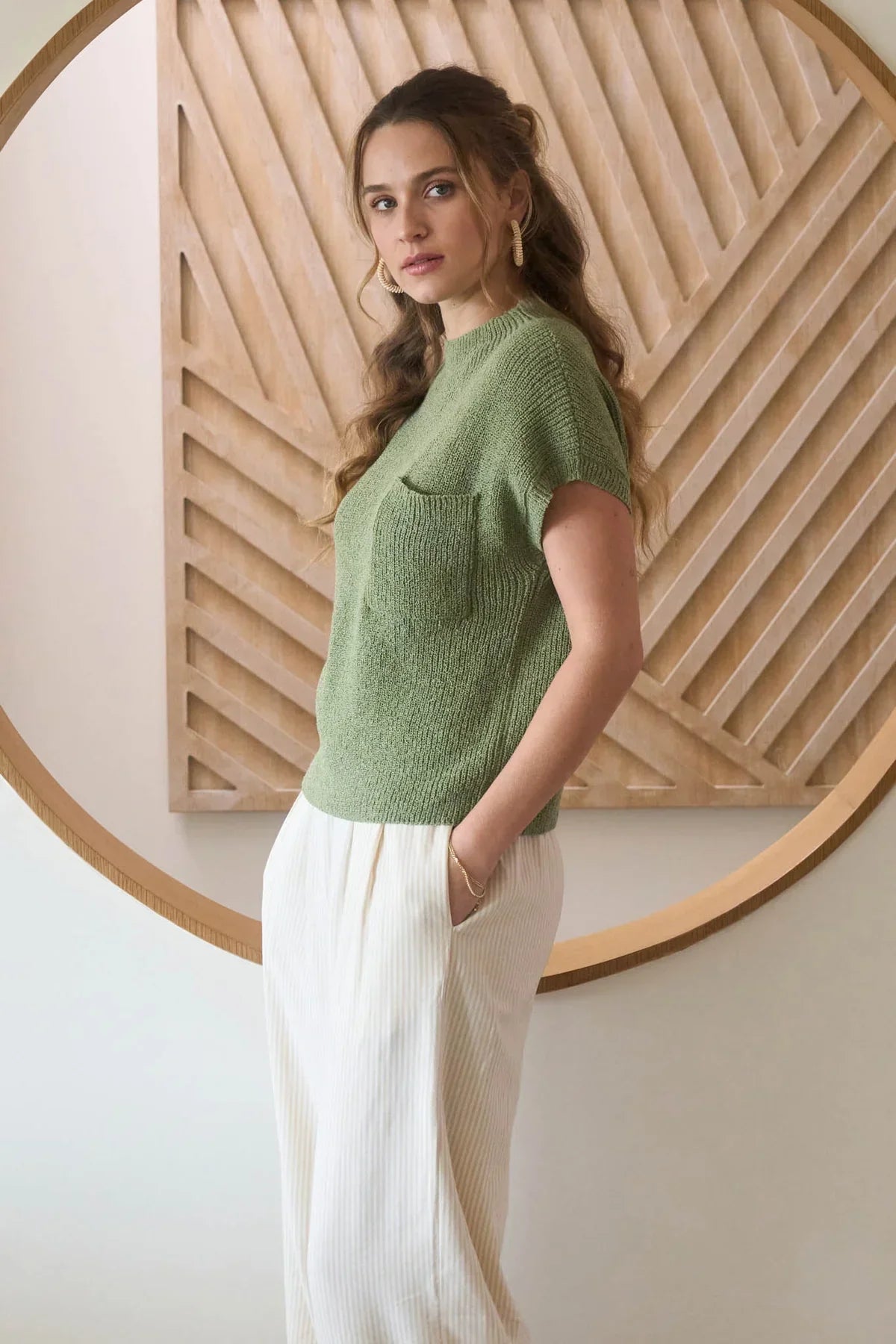 Women’s boho chic mock neck sweater with pocket detail and flowing cream pants