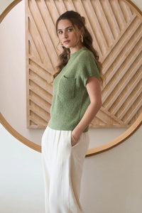 Women’s boho chic mock neck sweater with pocket detail and flowing cream pants
