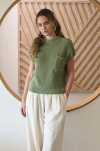 Women’s boho chic look featuring a mock neck sweater with chest pocket and wide-leg cream pants