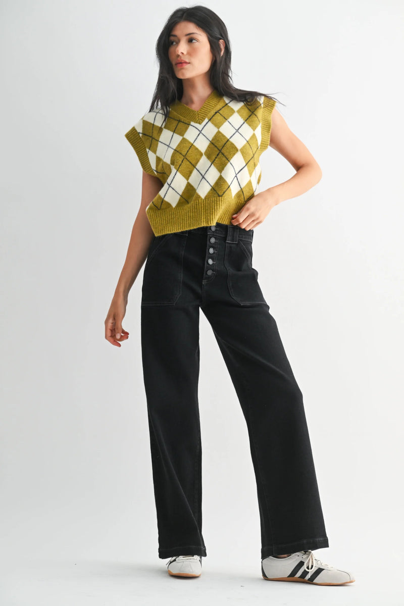 Mustard argyle sweater with slim wide leg denim jeans and white sneakers