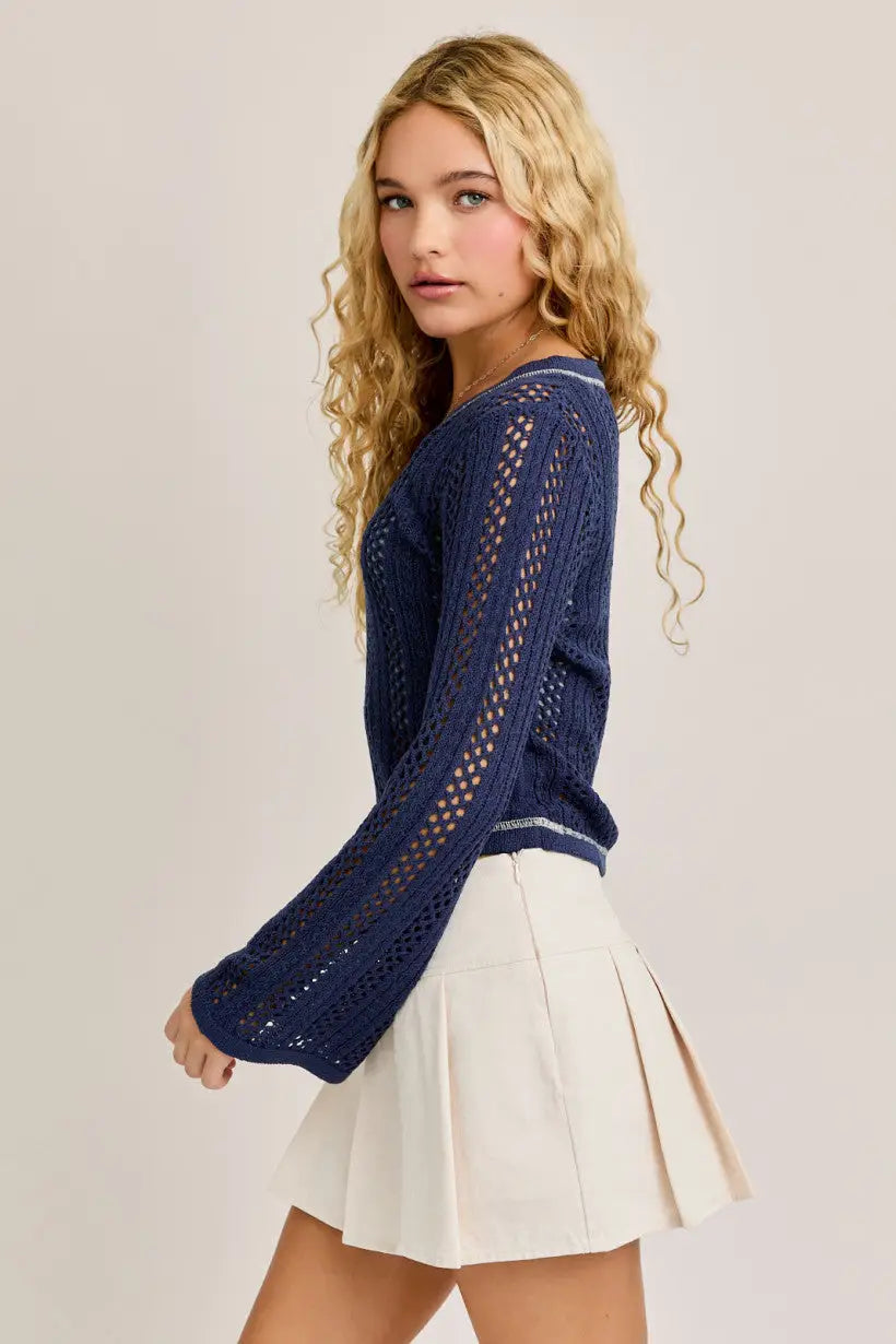 Navy blue knit sweater featuring a crochet contrast stitch in a stylish V-neck design