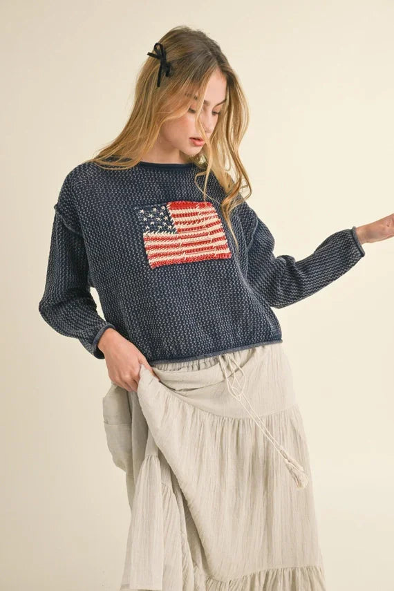 Navy blue knit sweater with American flag design from Shop Daisy, ideal for women’s boho chic clothing