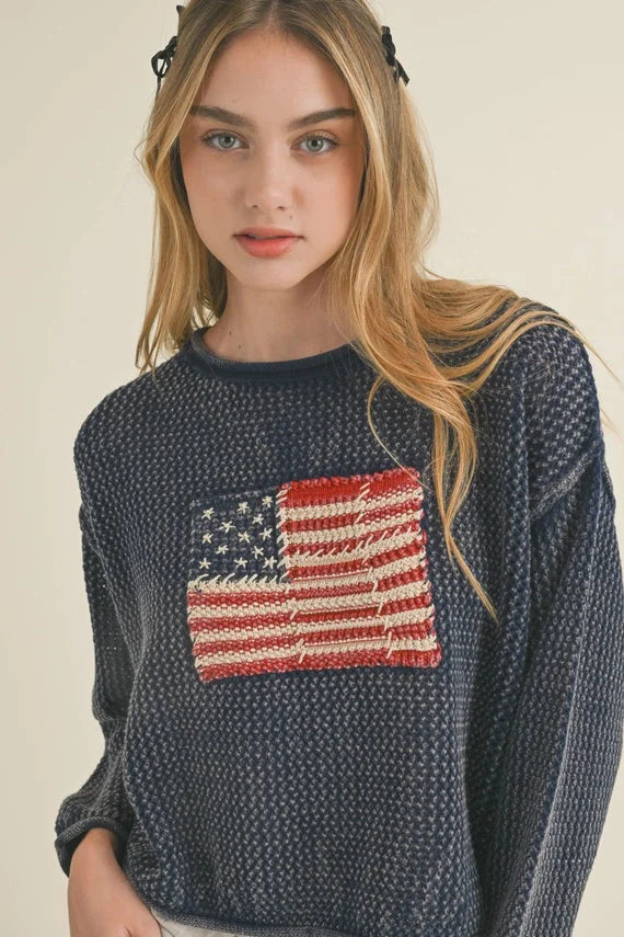 Navy blue knit sweater with American flag design, part of women’s boho chic clothing at Shop Daisy