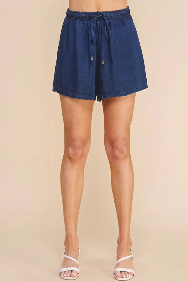 Navy blue washed denim high waisted tie shorts with a loose, flowy fit