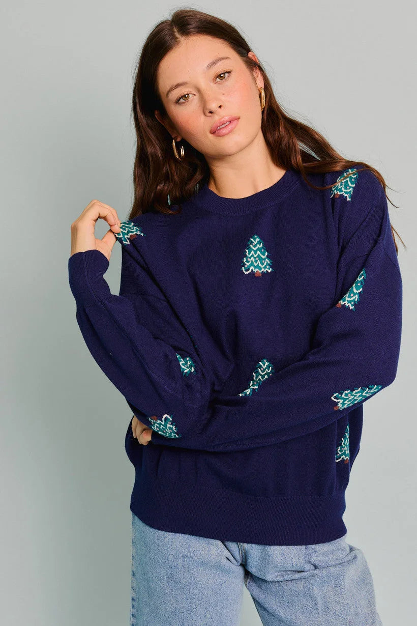 Navy blue sweater with teal Christmas tree patterns from Shop Daisy, women’s boho chic clothing