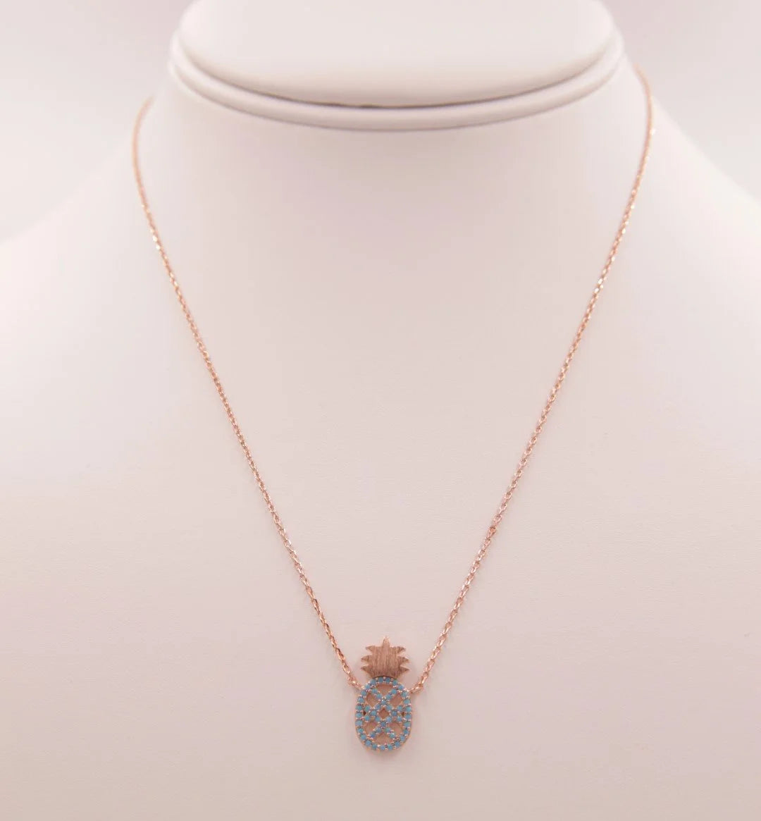 Dainty Turquoise Pineapple Necklace featuring a heart-shaped blue stone pendant