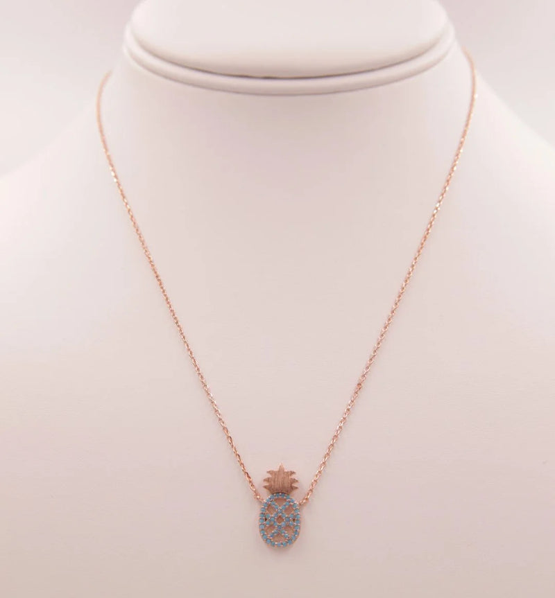 Dainty Turquoise Pineapple Necklace featuring a heart-shaped blue stone pendant