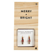 Nutcracker-themed Treasure Box Earrings displayed on a Merry Bright retail card