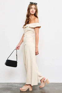 Off-shoulder cream ruffle jumpsuit with wide-leg pants from Shop Daisy’s women’s boho chic clothing