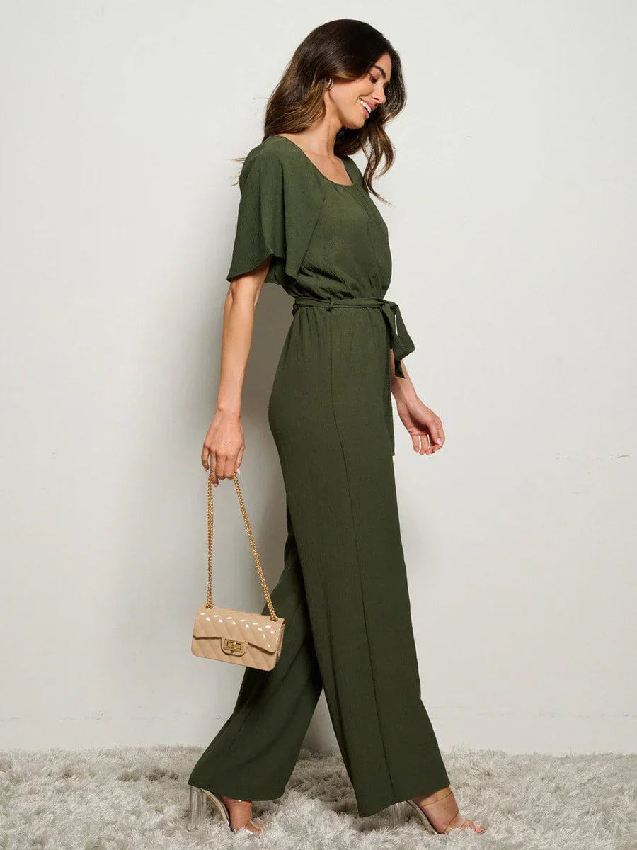 Olive green boho jumpsuit with short sleeves, wide-leg pants, and self-tie waist detail