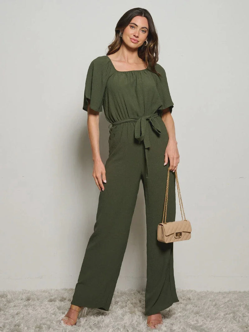 Olive green boho jumpsuit with short sleeves and a self-tie waist for a flowy look