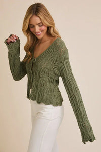 Olive green open knit cardigan with bell sleeves and tie bell front detail