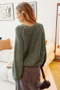 Olive green knit pullover sweater featuring ribbed texture and loose-fitting design